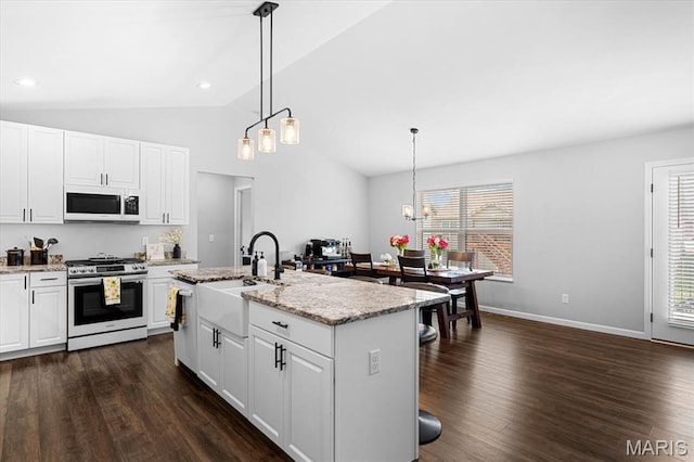 1433 Victoria Square Ct, Ofallon, IL 62269 - kitchen featuring gas stove, white microwave, vaulted ceiling, dark wood-type flooring, and healthy amount of natural light