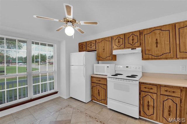 2961 Plum Leaf Cir, Saint Peters, MO 63303 - kitchen featuring white appliances, under cabinet range hood, brown cabinetry, light countertops, and ceiling fan