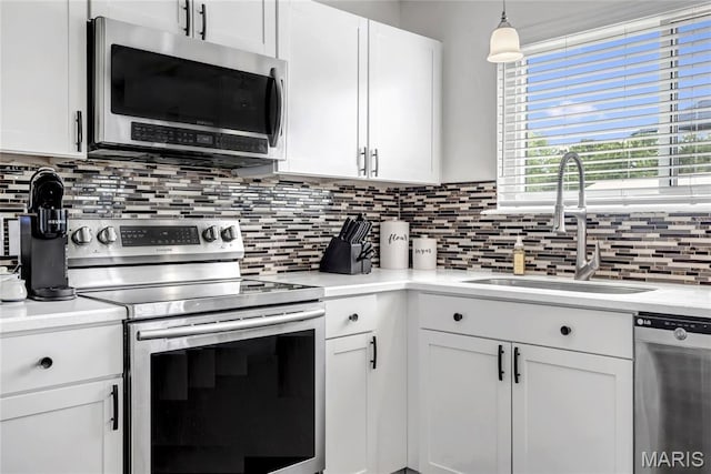 22 Dean Wells Ct, Warrenton, MO 63383 - kitchen with stainless steel appliances, decorative backsplash, and white cabinets