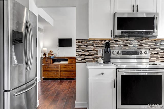 22 Dean Wells Ct, Warrenton, MO 63383 - kitchen with appliances with stainless steel finishes, light countertops, dark wood-type flooring, backsplash, and white cabinets