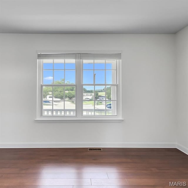 22 Dean Wells Ct, Warrenton, MO 63383 - unfurnished room with dark wood-style flooring and healthy amount of natural light