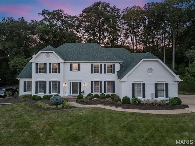 17527 Adams Way Ct, Wildwood, MO 63005 - view of front facade with roof with shingles, a front lawn, and view of wooded area