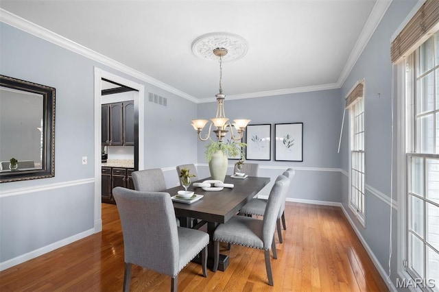 17527 Adams Way Ct, Wildwood, MO 63005 - dining space with light wood finished floors, a chandelier, and crown molding