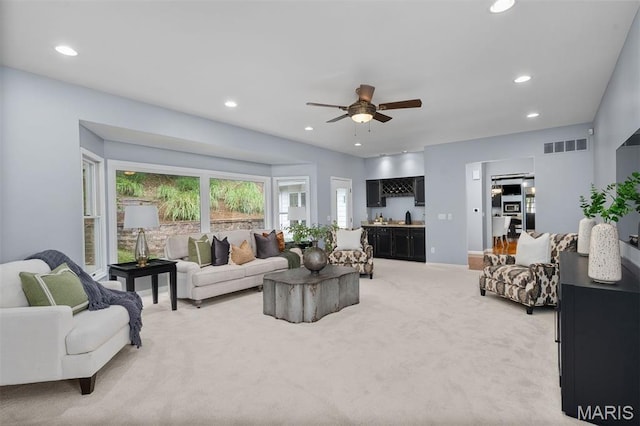 17527 Adams Way Ct, Wildwood, MO 63005 - living room with light colored carpet, a ceiling fan, recessed lighting, and bar