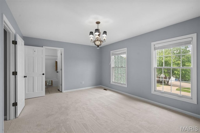17527 Adams Way Ct, Wildwood, MO 63005 - unfurnished bedroom featuring light colored carpet and a chandelier