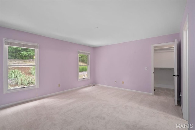 17527 Adams Way Ct, Wildwood, MO 63005 - unfurnished bedroom with multiple windows, light carpet, and a spacious closet