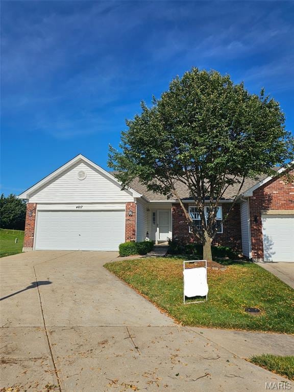 4817 Misty Wood Ct, Wentzville, MO 63385 - ranch-style house with brick siding, concrete driveway, a garage, and a front yard