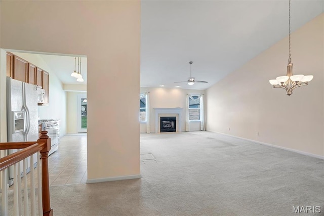 4817 Misty Wood Ct, Wentzville, MO 63385 - unfurnished living room featuring a ceiling fan, a chandelier, a fireplace, light carpet, and vaulted ceiling