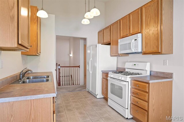 4817 Misty Wood Ct, Wentzville, MO 63385 - kitchen with white appliances, a high ceiling, light countertops, pendant lighting, and light tile patterned floors