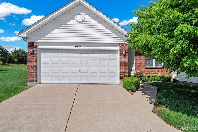 4817 Misty Wood Ct, Wentzville, MO 63385 - view of front of house with brick siding, concrete driveway, a front yard, and an attached garage