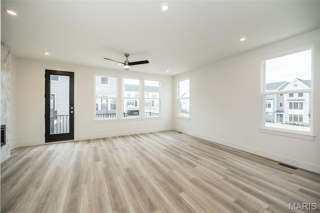 8935 E Gateway Hts Unit 94-808, Richmond Heights, MO 63144 - unfurnished living room featuring light wood-type flooring, a ceiling fan, a premium fireplace, and recessed lighting