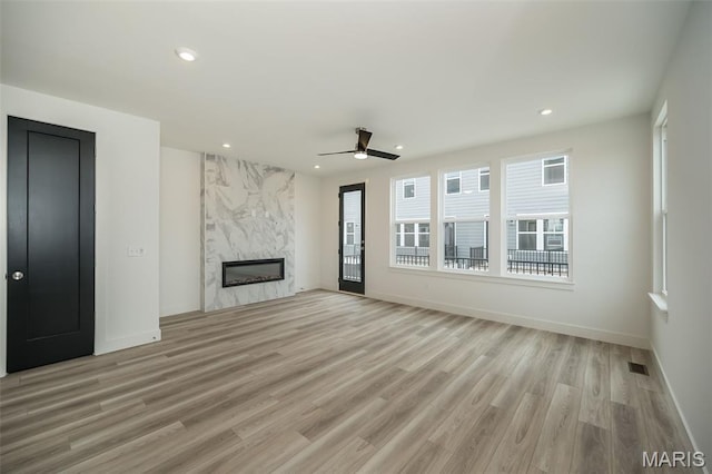 8935 E Gateway Hts Unit 94-808, Richmond Heights, MO 63144 - unfurnished living room with a premium fireplace, recessed lighting, a ceiling fan, and light wood finished floors