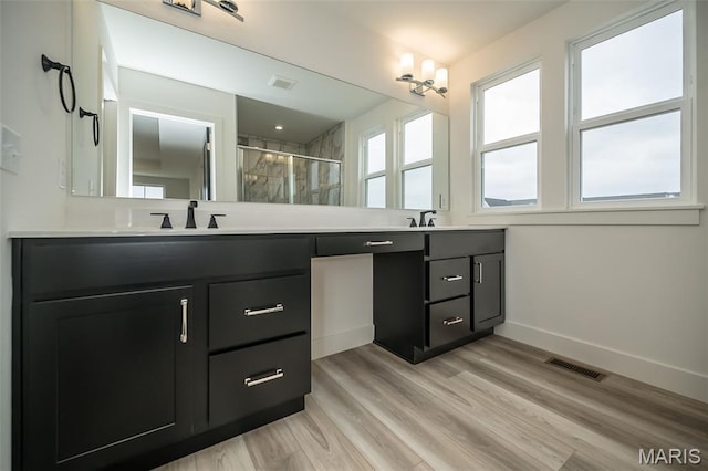 8935 E Gateway Hts Unit 94-808, Richmond Heights, MO 63144 - full bath featuring double vanity, a stall shower, and wood finished floors