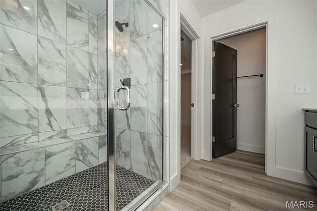 8935 E Gateway Hts Unit 94-808, Richmond Heights, MO 63144 - bathroom with a marble finish shower, wood finished floors, and vanity
