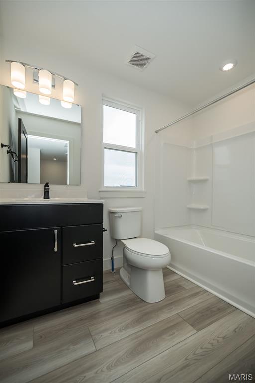 8935 E Gateway Hts Unit 94-808, Richmond Heights, MO 63144 - bathroom featuring vanity, bathtub / shower combination, wood finished floors, and recessed lighting