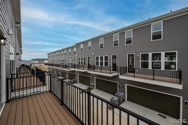 8935 E Gateway Hts Unit 94-808, Richmond Heights, MO 63144 - wooden deck featuring a garage and a residential view
