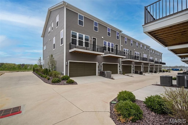8935 E Gateway Hts Unit 94-808, Richmond Heights, MO 63144 - view of building exterior with a garage and driveway