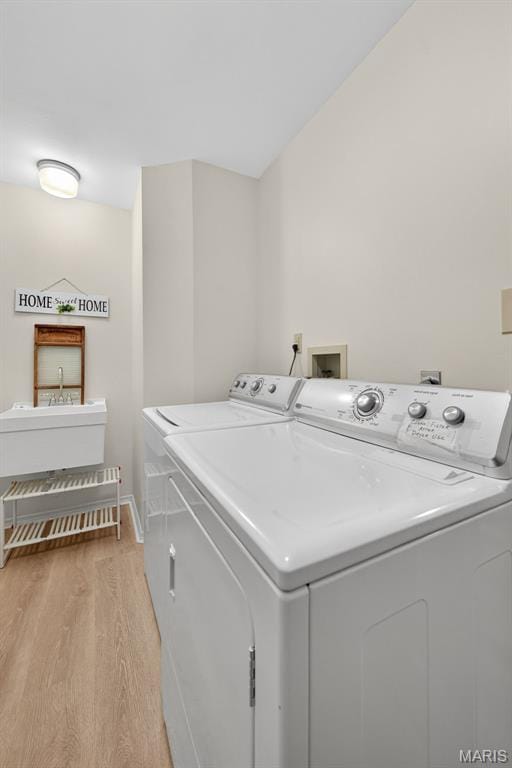 425 Charter Way Dr, Wildwood, MO 63040 - washroom with washing machine and dryer and light wood-style floors