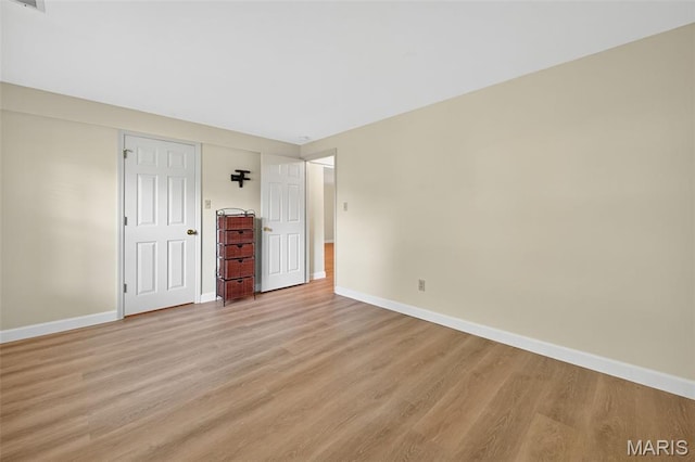 425 Charter Way Dr, Wildwood, MO 63040 - unfurnished bedroom featuring baseboards and light wood-style flooring