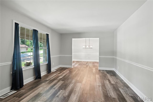 20 Hiddenbrook Dr, Black Jack, MO 63033 - unfurnished dining area with dark wood-type flooring and a chandelier