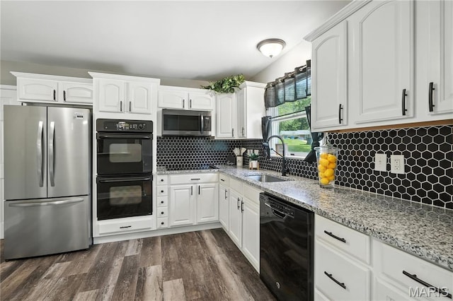20 Hiddenbrook Dr, Black Jack, MO 63033 - kitchen featuring black appliances, light stone counters, white cabinetry, and dark wood-style floors