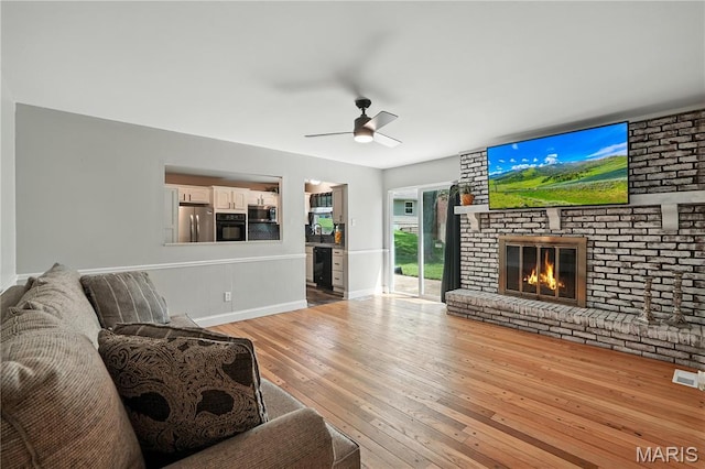 20 Hiddenbrook Dr, Black Jack, MO 63033 - living room featuring ceiling fan, light wood-style floors, and a fireplace