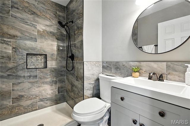 20 Hiddenbrook Dr, Black Jack, MO 63033 - bathroom with tile walls, tiled shower, vanity, and a wainscoted wall