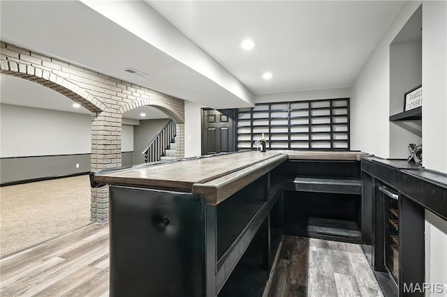 20 Hiddenbrook Dr, Black Jack, MO 63033 - bar with wood finished floors, stairway, arched walkways, and recessed lighting