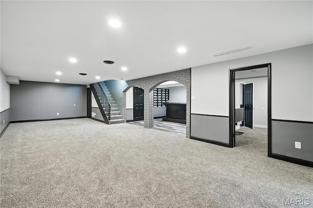 20 Hiddenbrook Dr, Black Jack, MO 63033 - unfurnished living room with arched walkways, carpet floors, stairway, and recessed lighting