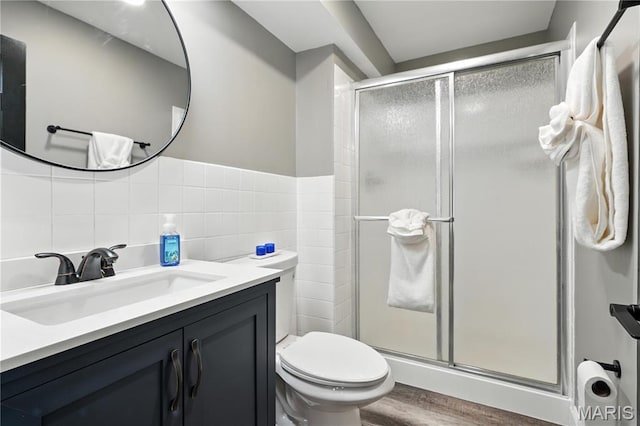 20 Hiddenbrook Dr, Black Jack, MO 63033 - full bathroom featuring a shower stall, vanity, wood finished floors, and tile walls