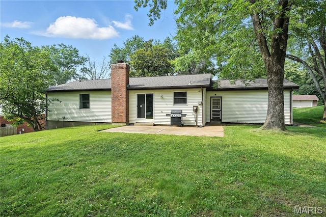 20 Hiddenbrook Dr, Black Jack, MO 63033 - back of house with a patio area, a lawn, and a chimney