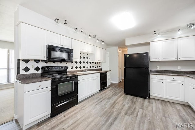 2313 College, Belleville, IL 62221 - kitchen with black appliances, backsplash, dark countertops, and white cabinetry