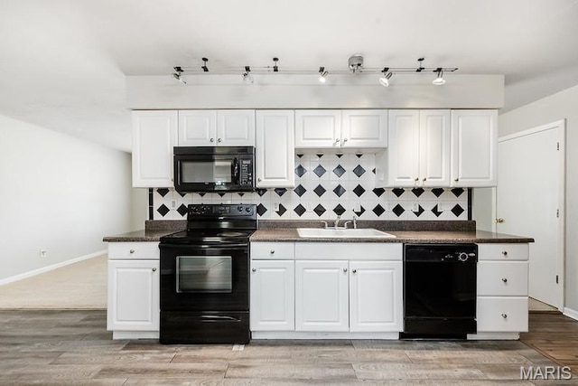 2313 College, Belleville, IL 62221 - kitchen with black appliances, dark countertops, tasteful backsplash, and white cabinets