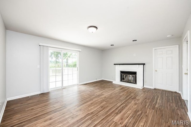 2313 College, Belleville, IL 62221 - unfurnished living room with wood finished floors and a glass covered fireplace