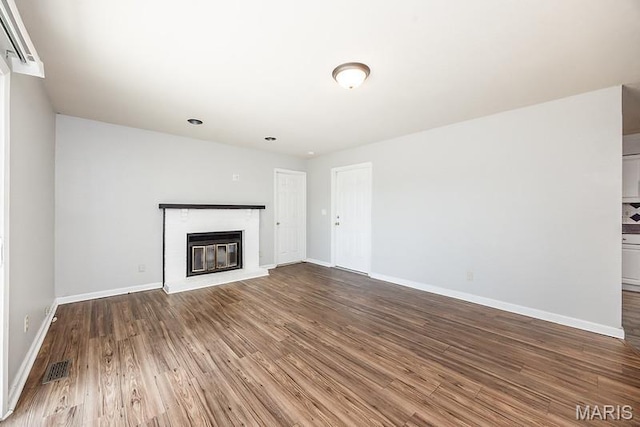 2313 College, Belleville, IL 62221 - unfurnished living room featuring wood finished floors and a glass covered fireplace