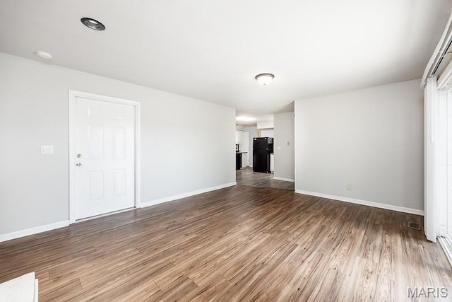 2313 College, Belleville, IL 62221 - unfurnished living room with wood finished floors and baseboards