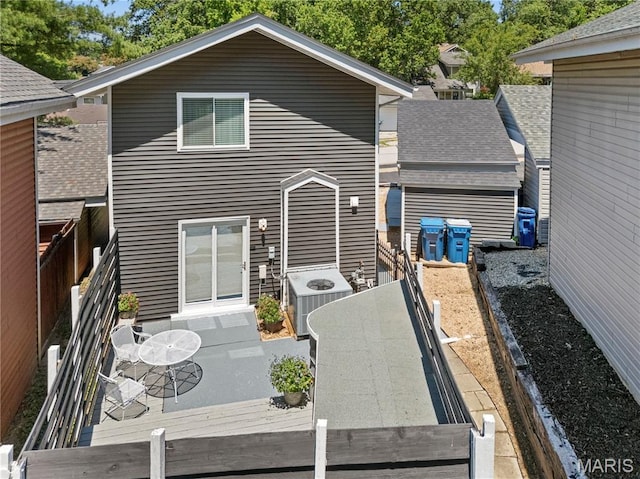 420 Echo Hill Dr, Ballwin, MO 63021 - back of house featuring a deck, a fenced backyard, outdoor dining area, and a shingled roof