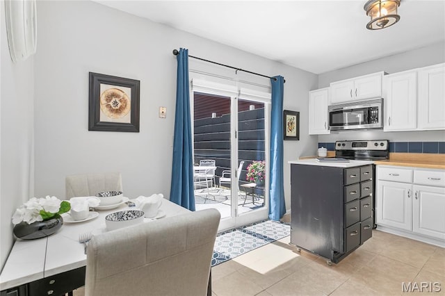 420 Echo Hill Dr, Ballwin, MO 63021 - kitchen featuring stainless steel appliances, white cabinets, light countertops, and light tile patterned floors