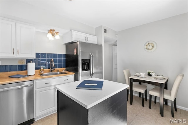 420 Echo Hill Dr, Ballwin, MO 63021 - kitchen with stainless steel appliances, light tile patterned floors, and white cabinets