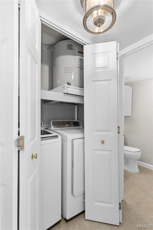 420 Echo Hill Dr, Ballwin, MO 63021 - laundry area featuring washing machine and dryer, a chandelier, light tile patterned flooring, and water heater