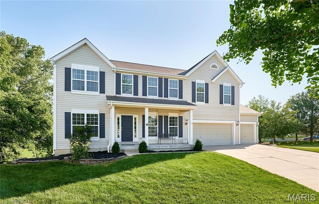 20 Airfield Crossing Court, Lake St Louis, MO 63367 - view of front of property with covered porch, concrete driveway, a front yard, and an attached garage