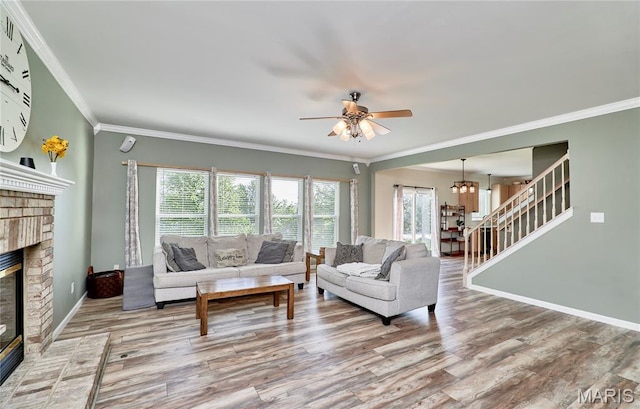 20 Airfield Crossing Court, Lake St Louis, MO 63367 - living room featuring plenty of natural light, wood finished floors, a fireplace, and ornamental molding