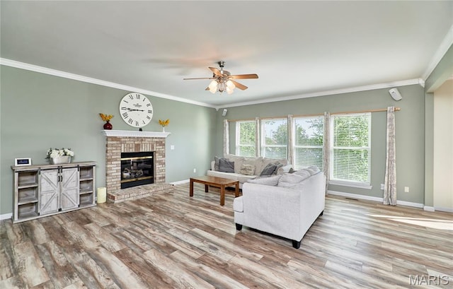 20 Airfield Crossing Court, Lake St Louis, MO 63367 - living room featuring a ceiling fan, wood finished floors, ornamental molding, and a brick fireplace
