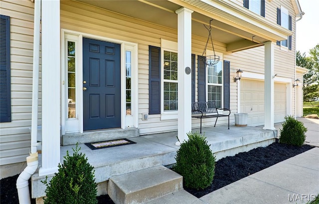 20 Airfield Crossing Court, Lake St Louis, MO 63367 - view of exterior entry featuring a porch, an attached garage, and concrete driveway