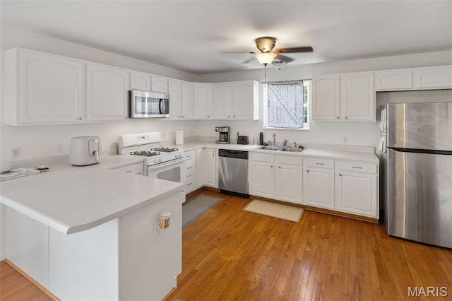 922 Benjamin Dr, Ofallon, IL 62269 - kitchen with appliances with stainless steel finishes, a peninsula, a ceiling fan, and white cabinets
