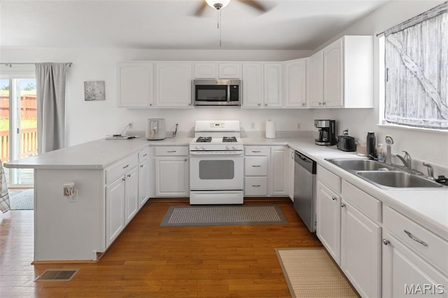 922 Benjamin Dr, Ofallon, IL 62269 - kitchen with appliances with stainless steel finishes, a peninsula, white cabinetry, and ceiling fan