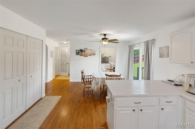 922 Benjamin Dr, Ofallon, IL 62269 - kitchen featuring separate washer and dryer, a peninsula, white cabinetry, a ceiling fan, and light countertops