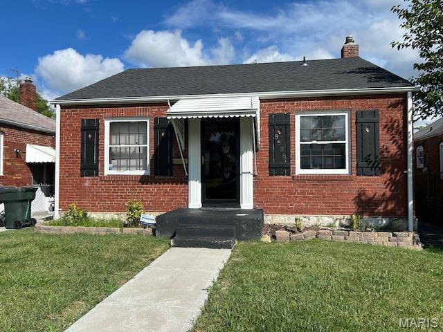8536 Partridge Ave, Saint Louis, MO 63147 - bungalow-style house featuring brick siding, a chimney, and a front lawn