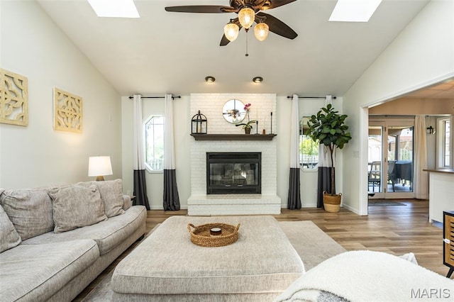 101 Archview Dr, Shiloh, IL 62221 - living area with lofted ceiling, healthy amount of natural light, a skylight, a fireplace, and wood finished floors