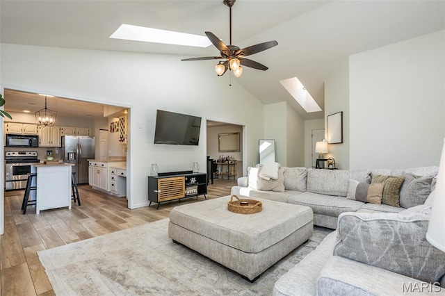 101 Archview Dr, Shiloh, IL 62221 - living room featuring a skylight, light wood-type flooring, ceiling fan, high vaulted ceiling, and a chandelier
